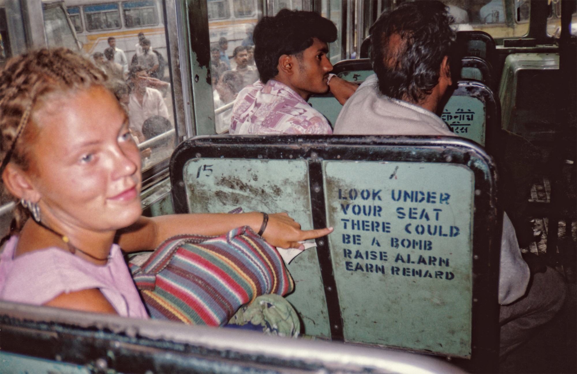 charnette woman pointing on a bomb scared bus in india travel like a local