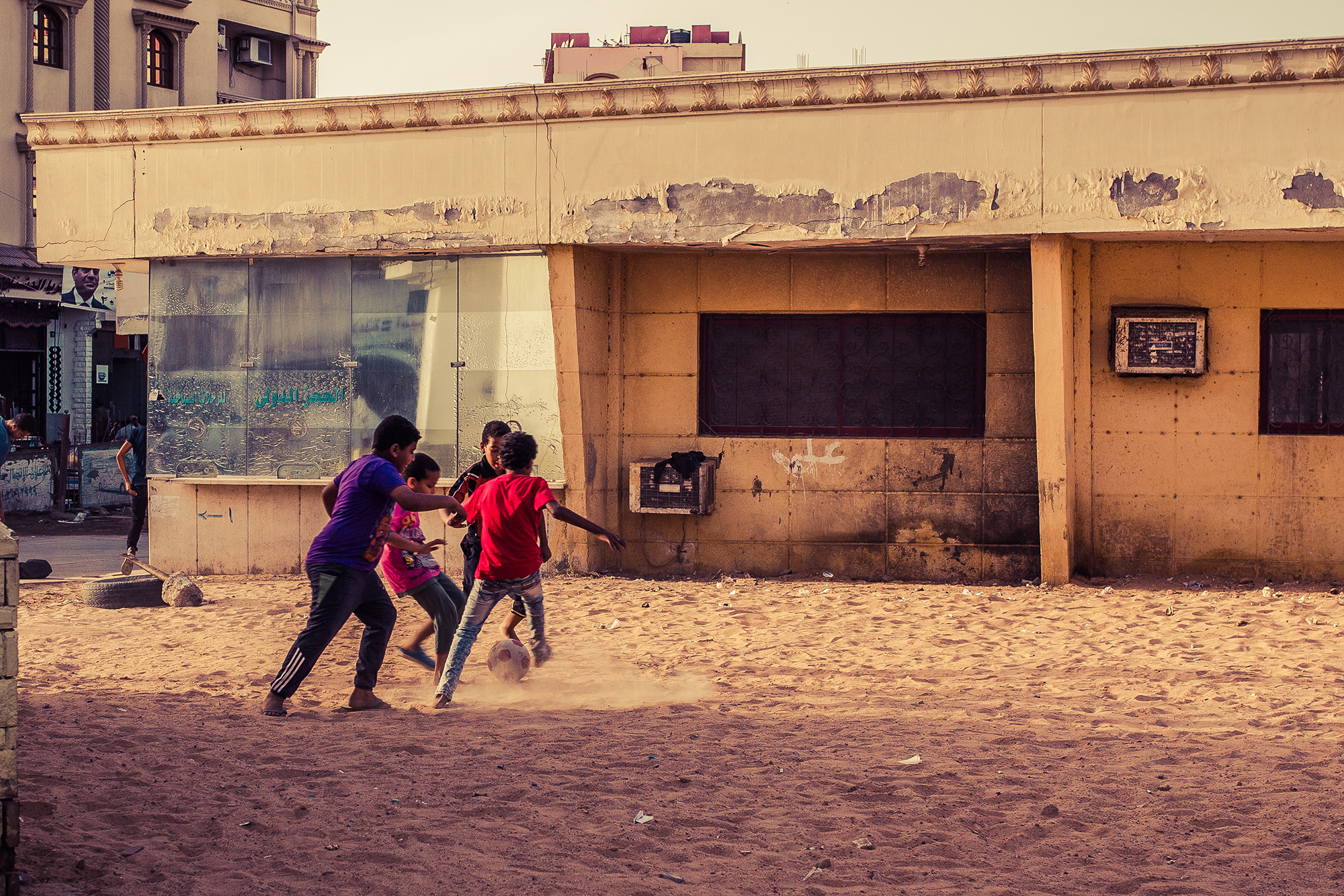 children playing football in the dirt in hurghada