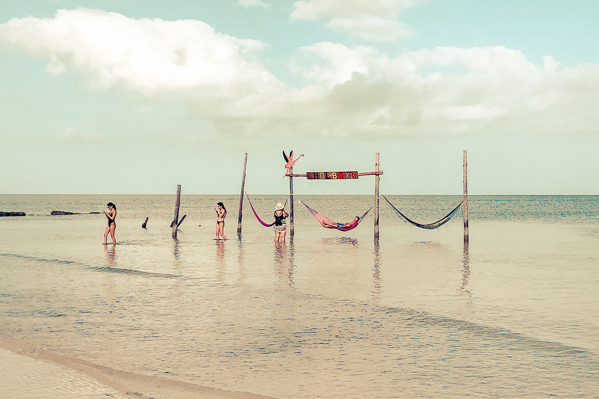 women with mobile phones by the holbox hammocks
